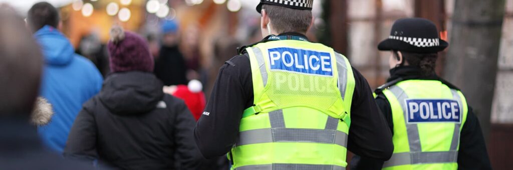 British police walking in a crowd, engaging with the public