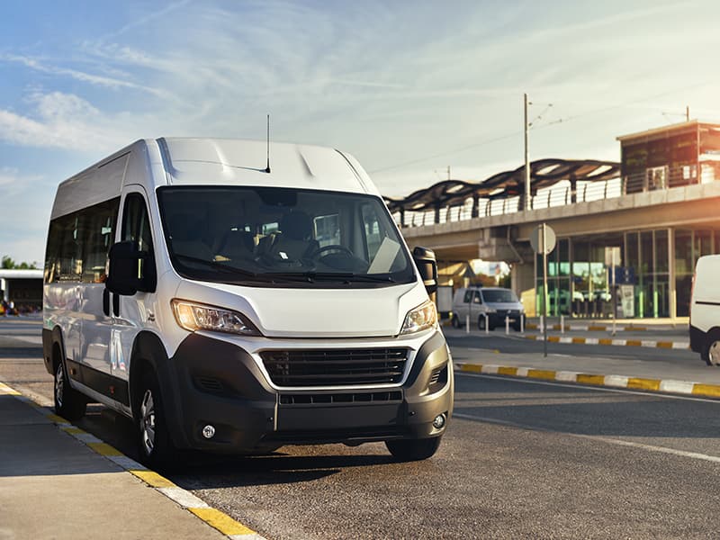 Microtransit services mini bus dropping off citizens at the airport