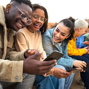 A diverse group of people enjoying a good experience on a mobile phone.