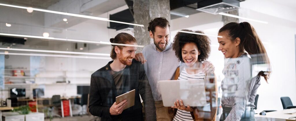 three people looking at a device