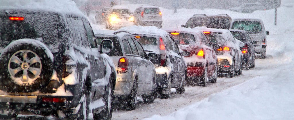 Cars in traffic on snow filled road