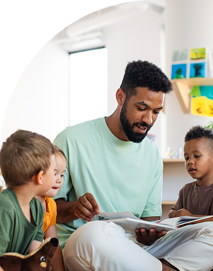 Early childhood teacher reading to children