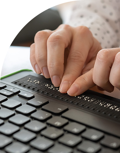 hands using brail display and keyboard