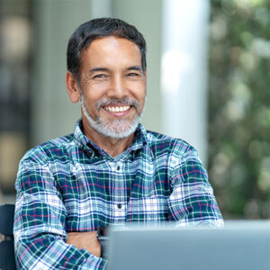 older man using laptop outside