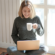 Person reading knowledge articles with coffee