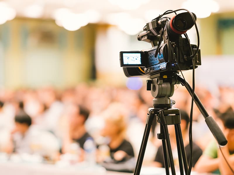 Camera recording and streaming a public meeting to improve accessibility and resident experience.